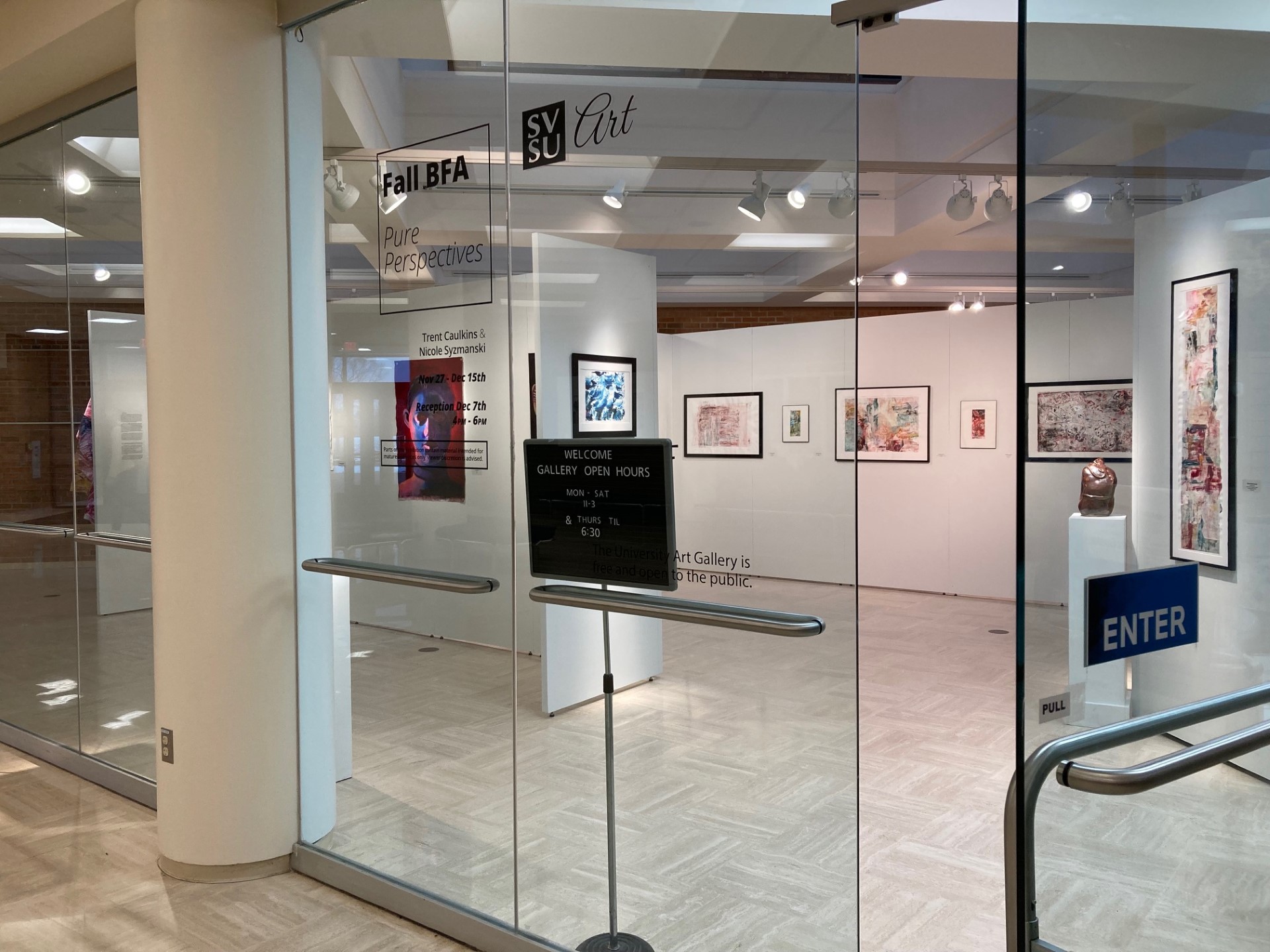 Entrance to caulkins-syzmanski BFA exhbition with disclaimer on glass